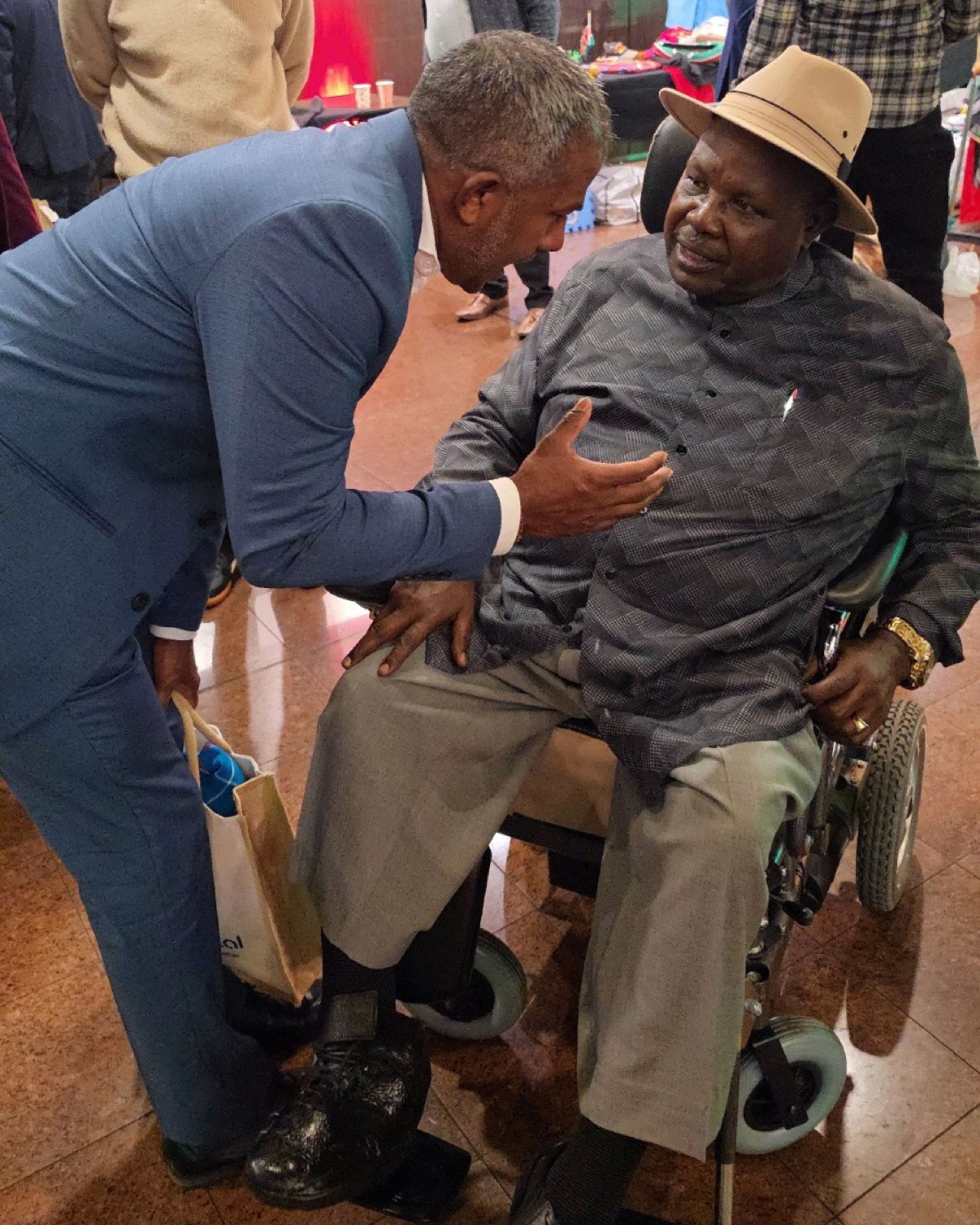 Sujan Selven speaking with a community member at a local gathering