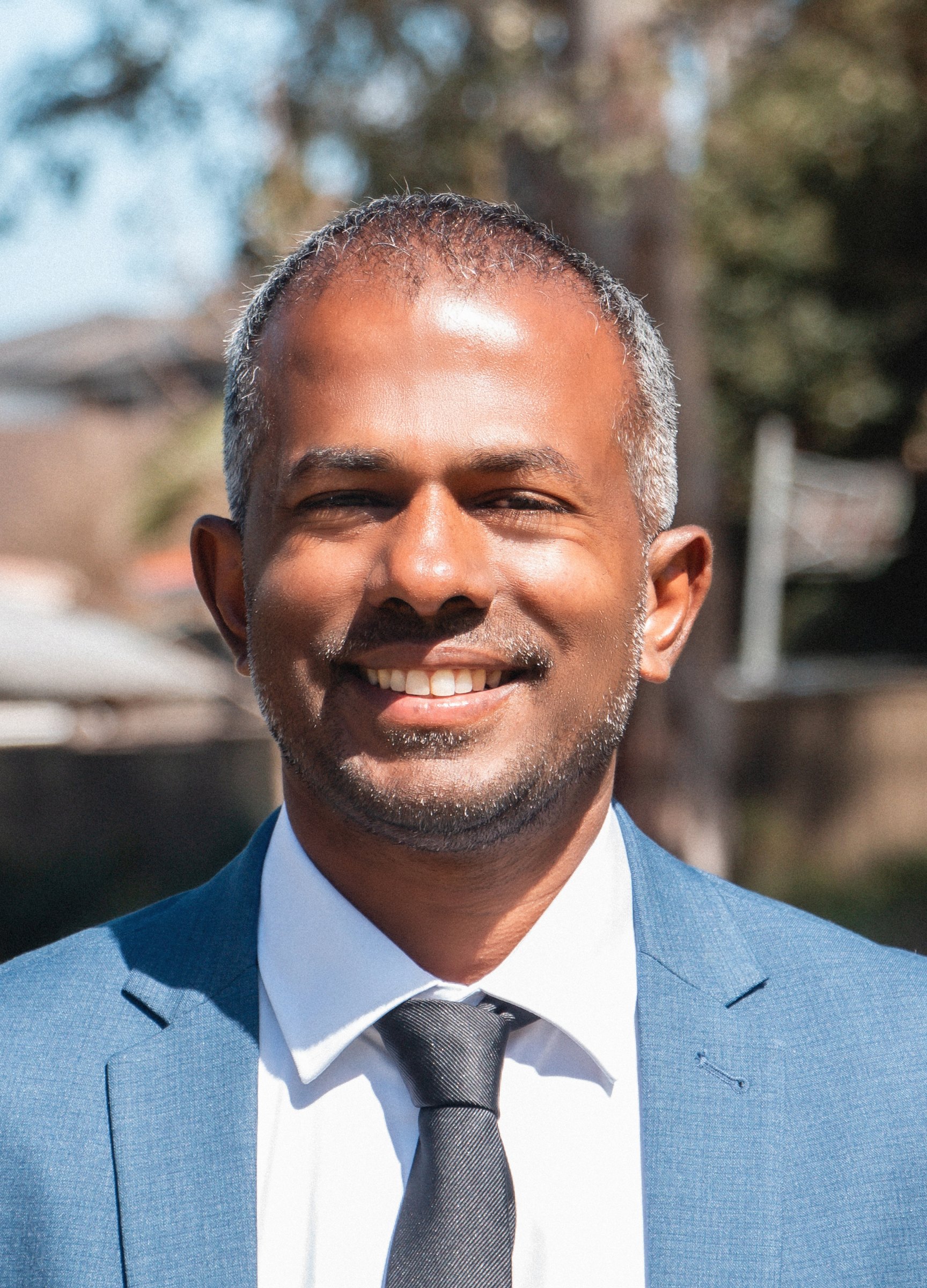 Sujan Selven smiling outdoors
